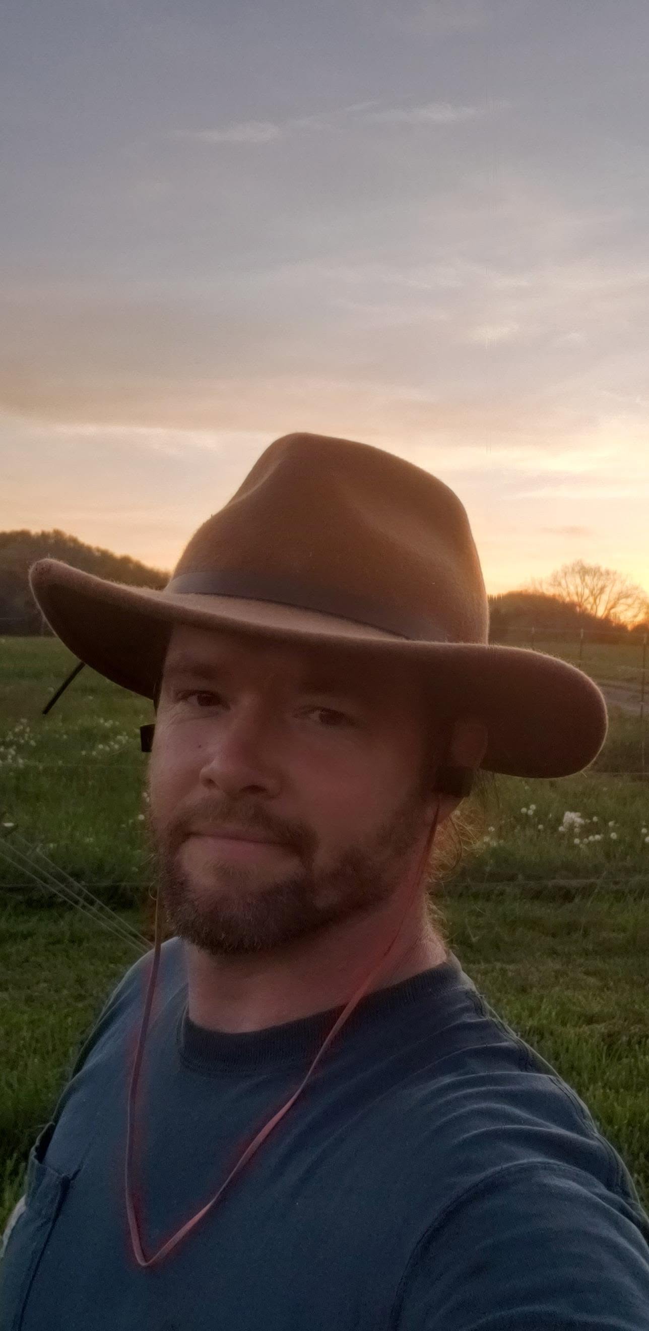 Lee Aaron West, founder of West Family Builders, on Appalachian land at sunset