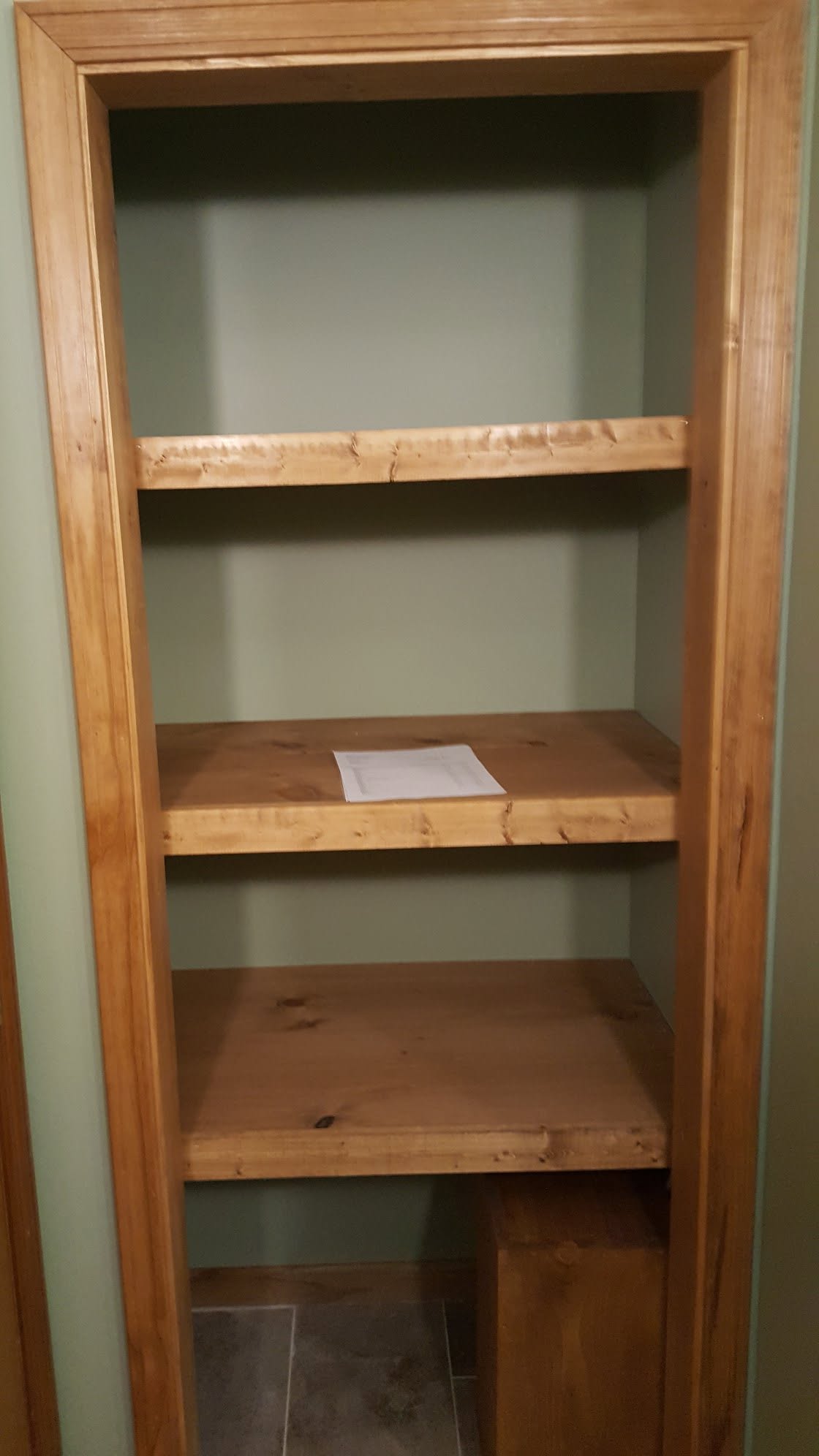 Custom knotty pine built-in bookshelf with matching trim