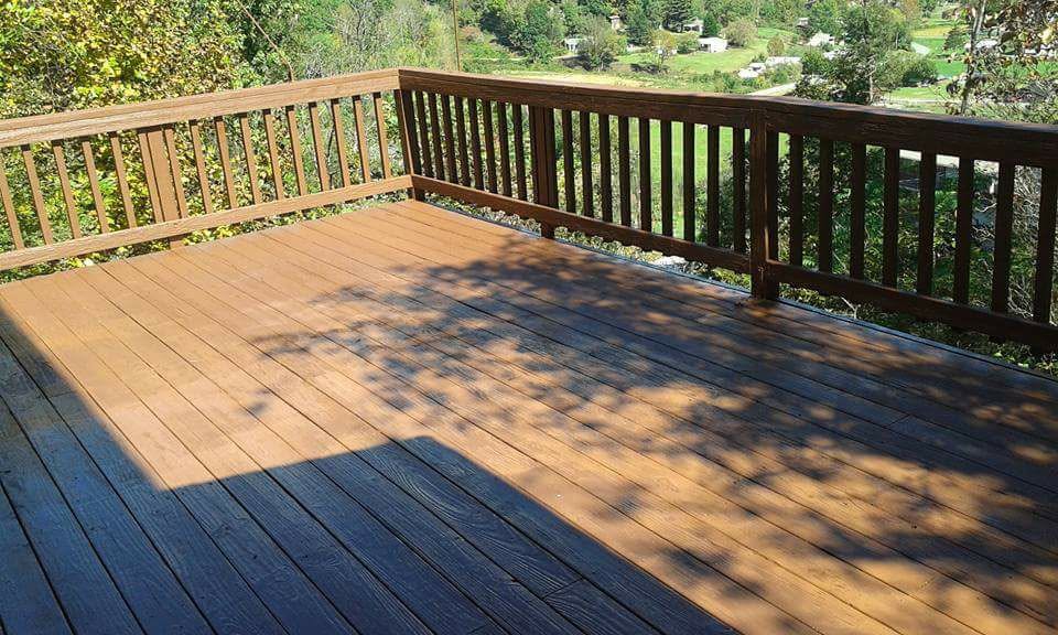 Refinished deck with two-tone stain and clean rails looking out over the mountains