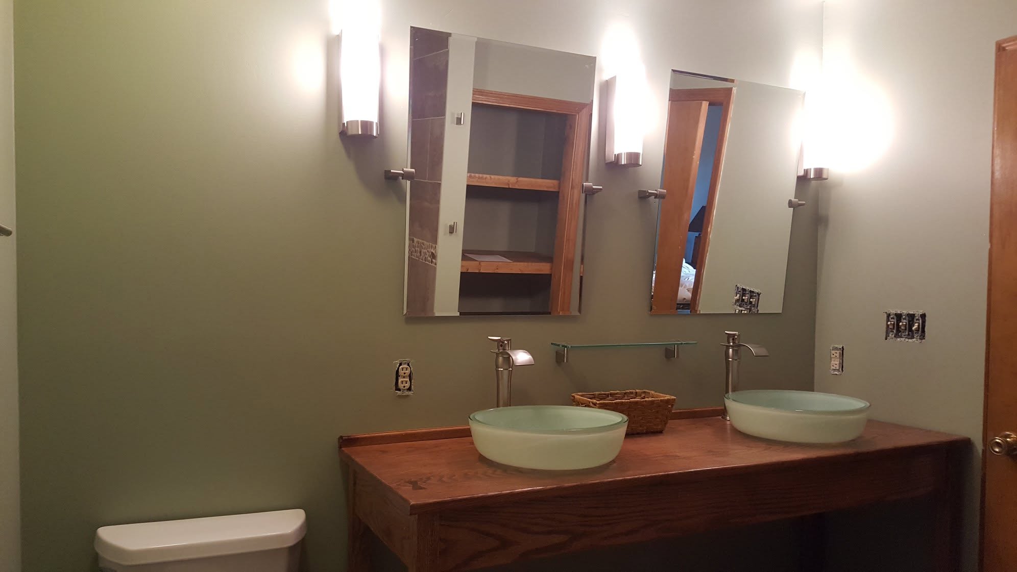 Bathroom vanity area with framed mirror and finished trim